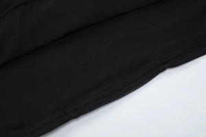Close-up of high-quality stitching and black knit fabric texture on a backless dress