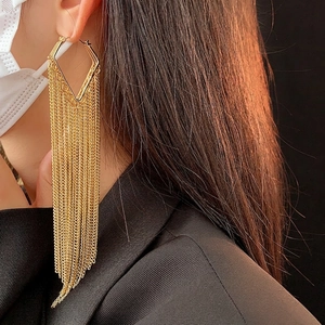 Elegant gold metal tassel drop earrings with geometric diamond stud on female model