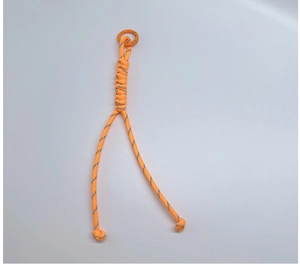 Detail of vibrant orange braided paracord keychain with reflective silver thread and metal clip