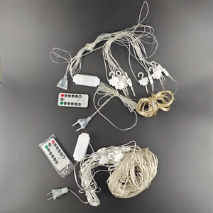 Detail view of 3x3m LED curtain lights with remote control, hooks, and power plug set