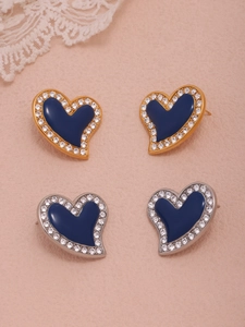 Detail of blue heart earrings with enamel inlay and sparkling rhinestone borders