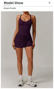 Detailed view of the twist knot hem on a grape purple V-neck athletic tennis dress