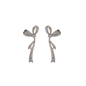 Sparkling zircon bow tassel earrings in silver finish with elegant dangling crystal chains