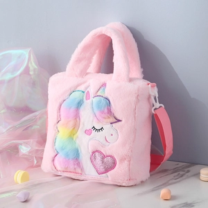 Detail of pink plush unicorn bag showing embroidered facial features and rainbow mane texture