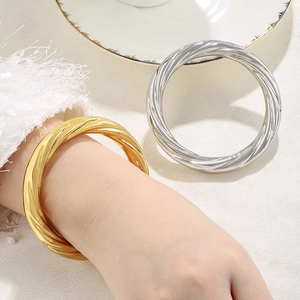 Twisted spiral 10mm stainless steel bangle in 18K gold and silver finish for women
