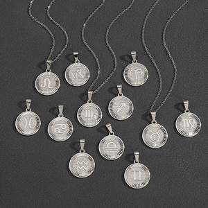 Twelve silver zodiac constellation pendants on thin chains displayed on dark fabric