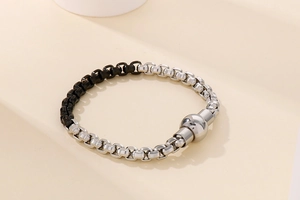 Macro view of two-tone industrial chain bracelet with magnetic clasp detail