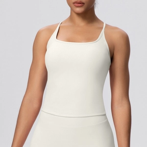 Detail of ivory yoga tank top with thin shoulder straps and moisture-wicking fabric