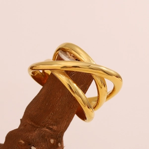Macro view of 18K gold plated stainless steel multi-layer crossover ring on wood stand