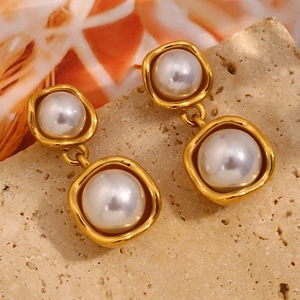 Detail showing double layered irregular gold frame drop earrings with elegant white pearls