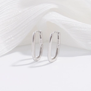 Detailed macro view of S925 sterling silver bamboo knot U-shaped earrings with hallmark