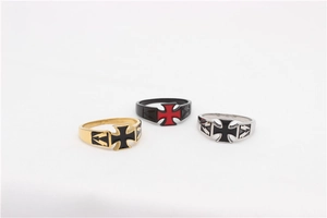 Detailed shot of retro cross rings in gold, silver, and black finishes with oil drop craft