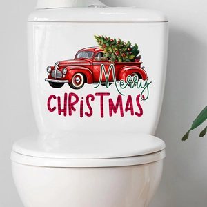 Detail of red vintage truck with Christmas tree wall decal on white ceramic surface