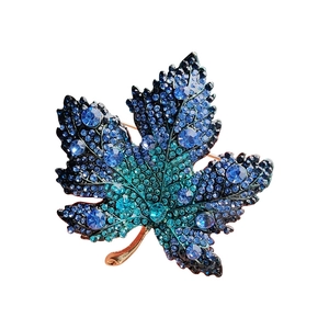 Exquisite gold-plated maple leaf brooch with blue-green gradient crystals and rhinestones