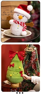 Detail of plush snowman and Christmas tree dolls with festive red bows and scarves