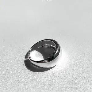 Detailed view of wide minimalist polished sterling silver dome ring with adjustable open band
