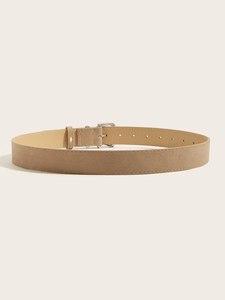 Detail of light brown suede leather belt featuring silver square buckle and fine stitching