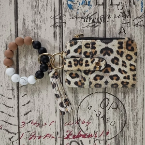Detail of leopard print card holder wallet with silicone bead wristlet and tassel