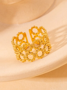 Macro view of adjustable gold plated beaded ring with elegant open cutout design