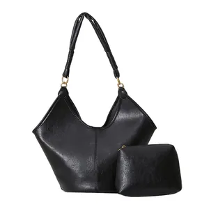Elegant black faux leather tote bag set with matching pouch and gold metal rings