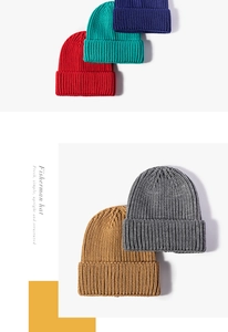 Detailed view of thick ribbed knit beanies in red, blue, grey, and caramel tones