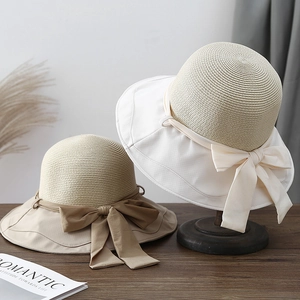 Women's summer straw sun hats with wide fabric brims and large decorative bow knots
