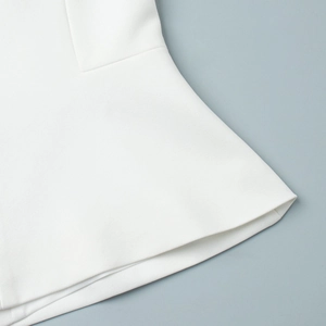 Detail of the high-density white fabric showing ruffled hem and fine twill texture