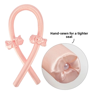 Detailed macro view showing hand-stitched ends for durability on pink satin hair curler set