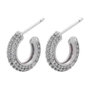 Close-up of minimalist brass huggie earrings with pavé set cubic zirconia stones