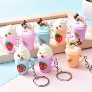 Macro detail of strawberry cream cup keychains in assorted pastel macarons colors