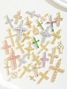 Close-up of colorful cubic zirconia cross pendants in gold and silver plating