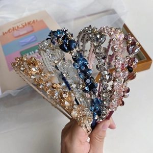 Detail of handmade crystal and pearl headband set in various champagne and blue tones