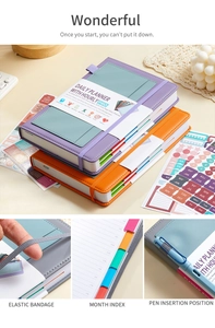Detail of undated daily planner with elastic strap, monthly tabs and pen holder