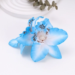 Detail of blue and white silk orchid flower clip with realistic petal textures and spots