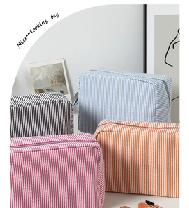 Close-up of colorful seersucker stripe toiletry bags with premium metal zippers