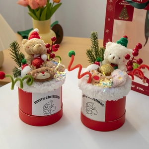 Detail of red Christmas plush bear gift box with festive pine branches and red berries decoration