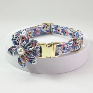 Detailed close-up of floral pet collar with gold metal buckle and pearl center flower