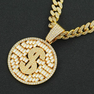 Iced out dollar sign pendant necklace with crystals on a golden cuban link chain