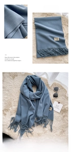 Detail of Morandi blue scarf featuring delicate tassels and soft cashmere texture