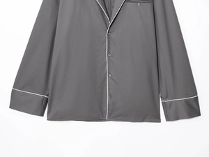 Detail of dark grey poplin shirt with button closure and lapel collar design