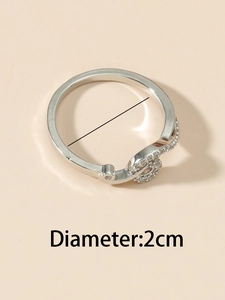 Macro shot of a silver interlaced ring with pavé crystals showing 2cm diameter scale