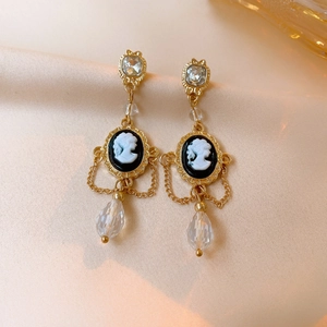French vintage pearl drop earrings with gold oval relief portrait on silk background