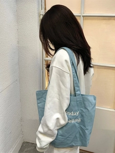 Light blue denim tote bag with Monday Feeling embroidery and shoulder straps