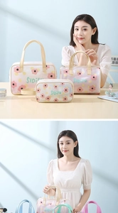 Three-piece floral PVC toiletry bag set with portable handles for travel storage