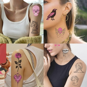 Detail showing waterproof temporary tattoos of pink skulls and roses on model's skin