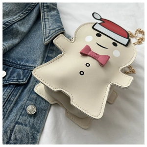 Detailed view of gingerbread man crossbody bag with festive red hat and gold chain strap