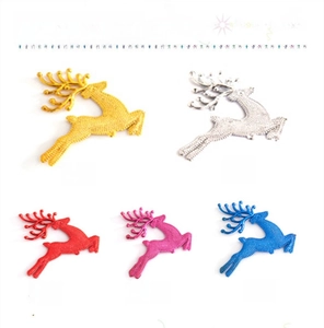 Detailed view of colorful glitter reindeer Christmas ornaments in five metallic finishes