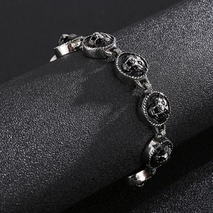 Macro shot of silver hip-hop tiger head steel bracelet with embossed links