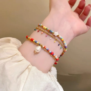 Colorful star beaded bracelet set with gold chains and pearl accent for women