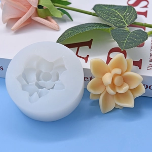 Detailed view of flower silicone mold with finished floral aromatherapy candle